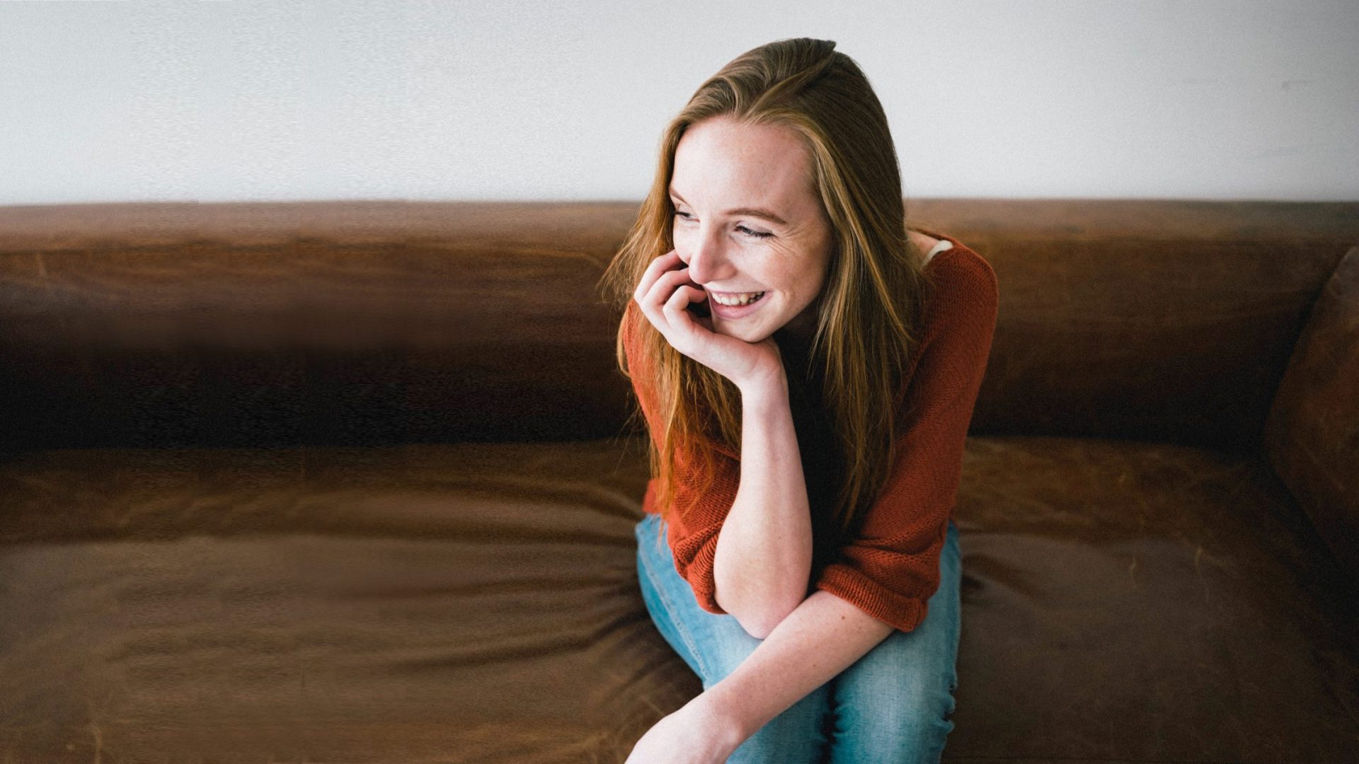 Girl smiling sitting on a sofa