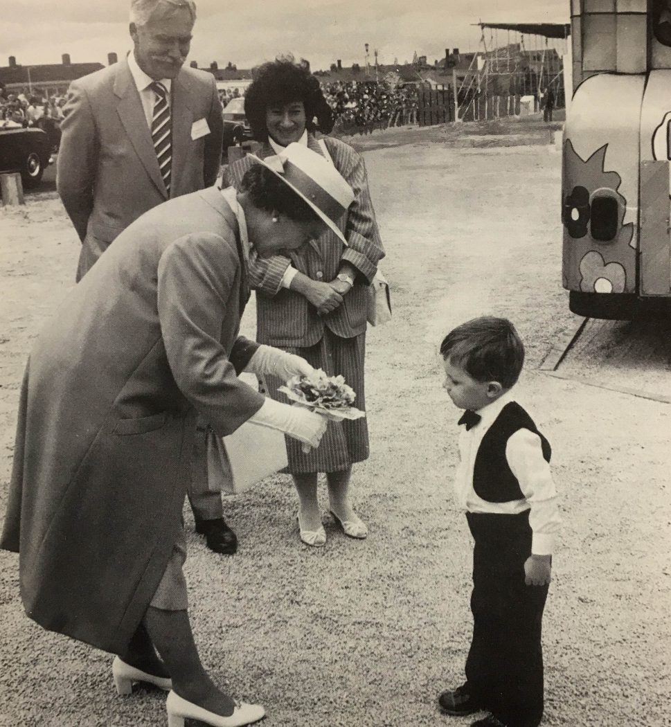 HM The Queen receives flowers during her visit to Nacro in the North East, 1986.