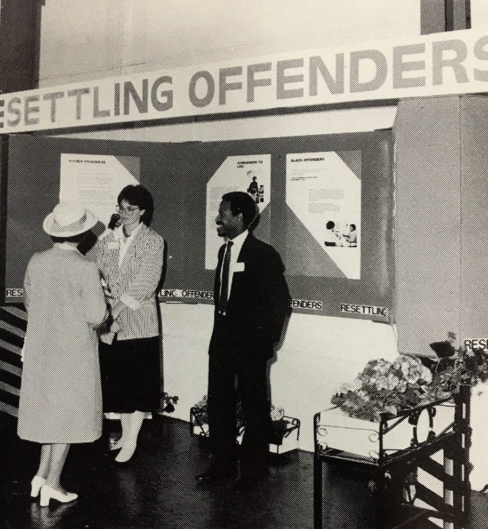 HM The Queen discusses Nacro's resettlement work with Helen Jones of the Prisoner's Link Unit and Basil Williams of the Ethnic Minorities Development Unit, during her visit to the North East, 1986.