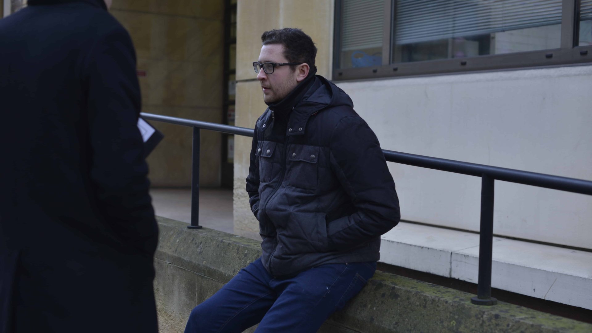 Man sitting on a wall outside
