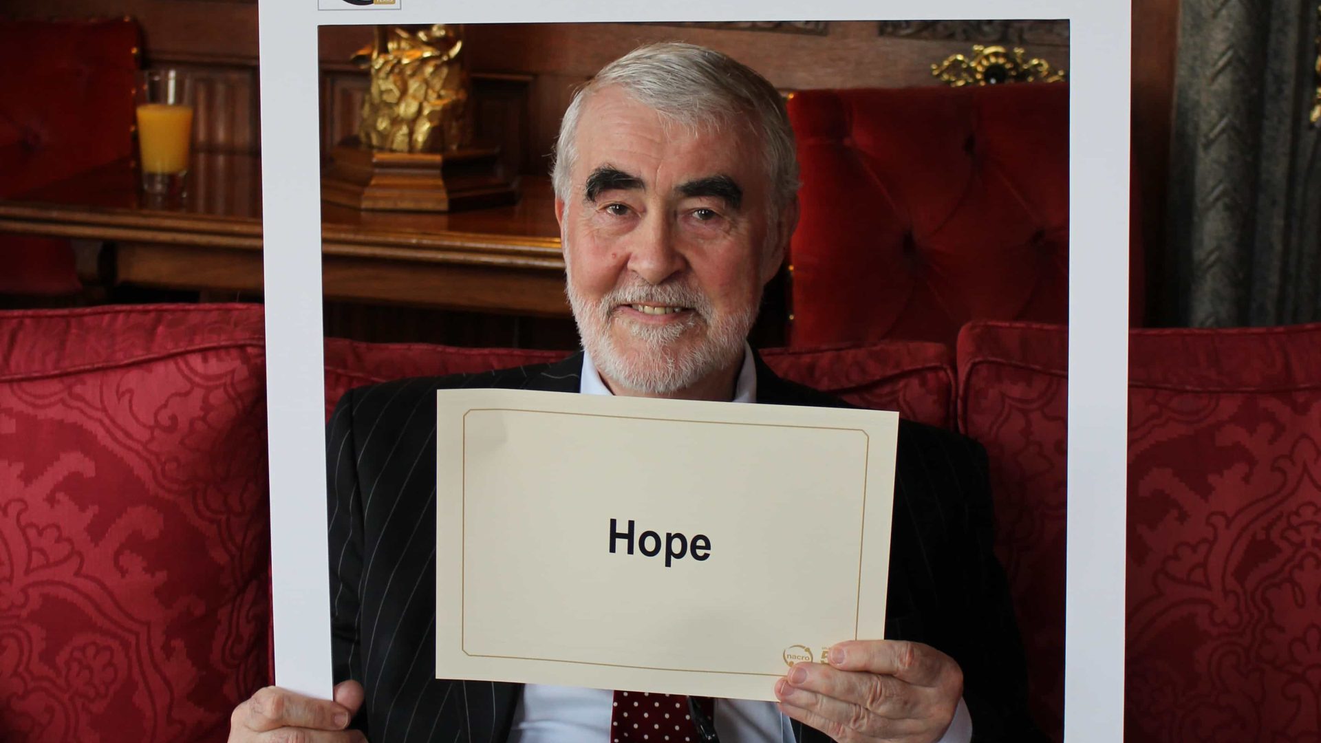 Man holding up a sign at Nacro's 50th Anniversary