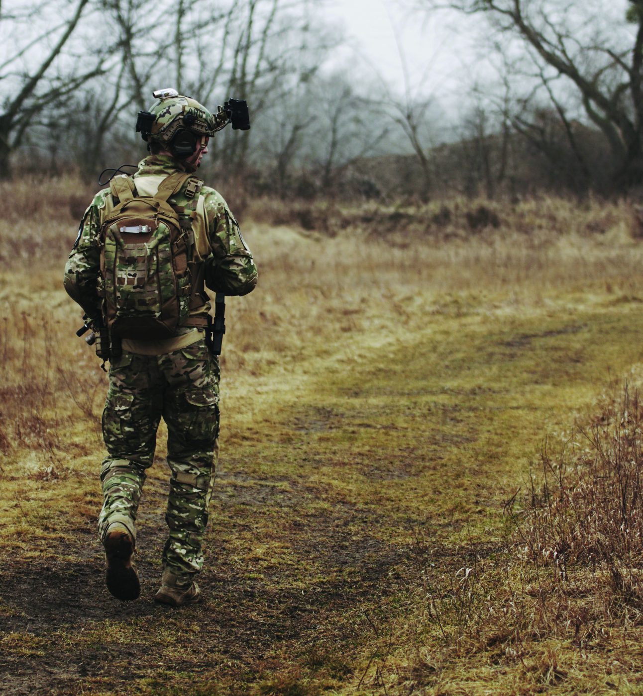 Army soldier walking in a field