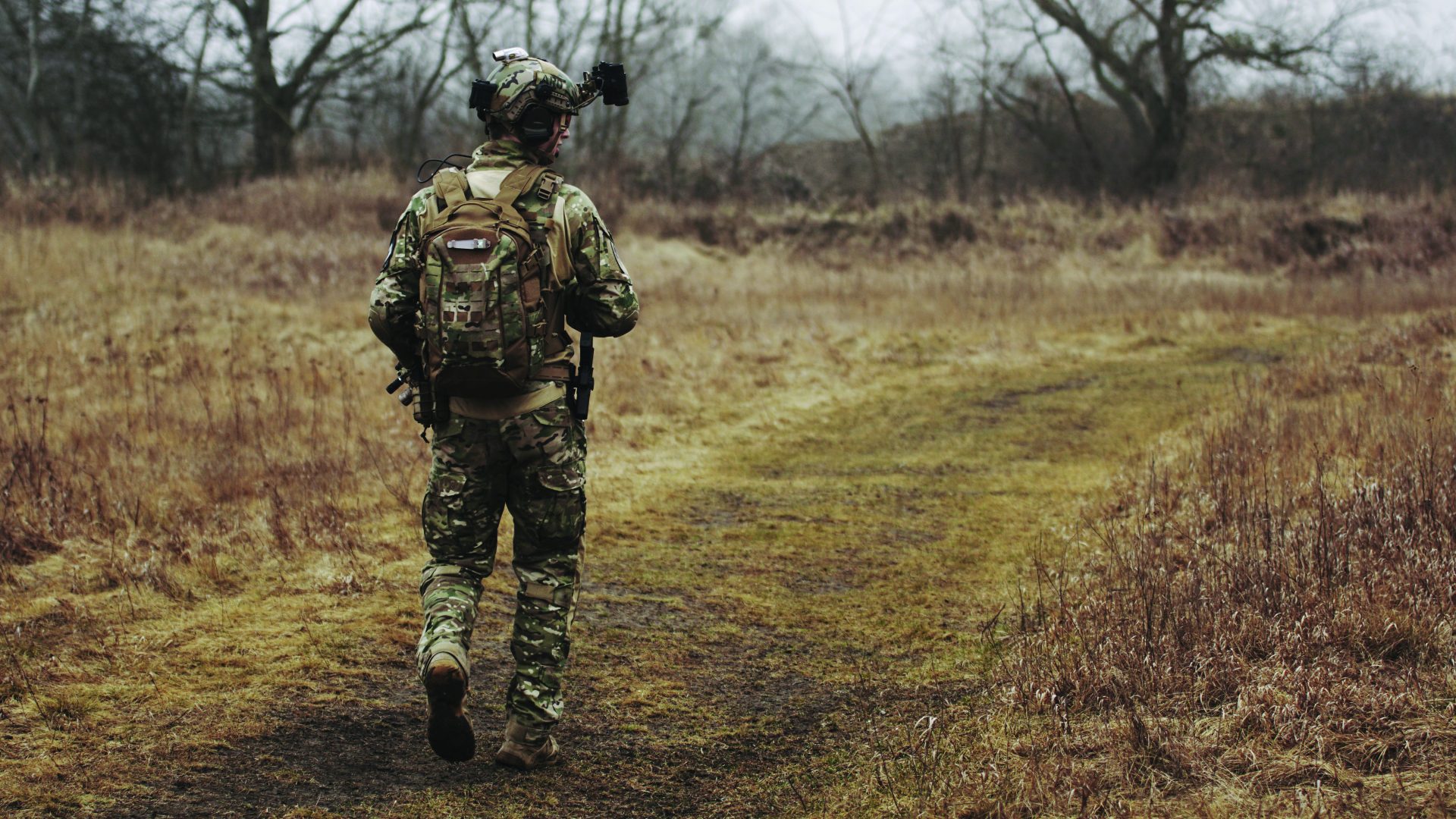 Army soldier walking in a field