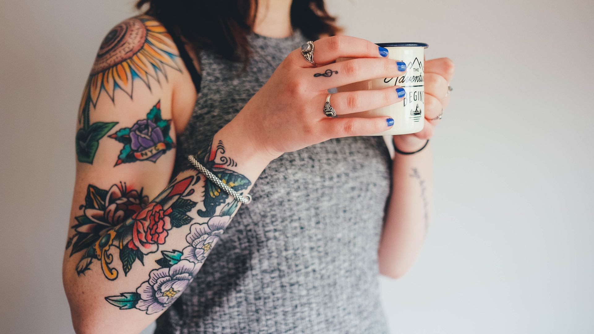 Tattooed lady holding a mug