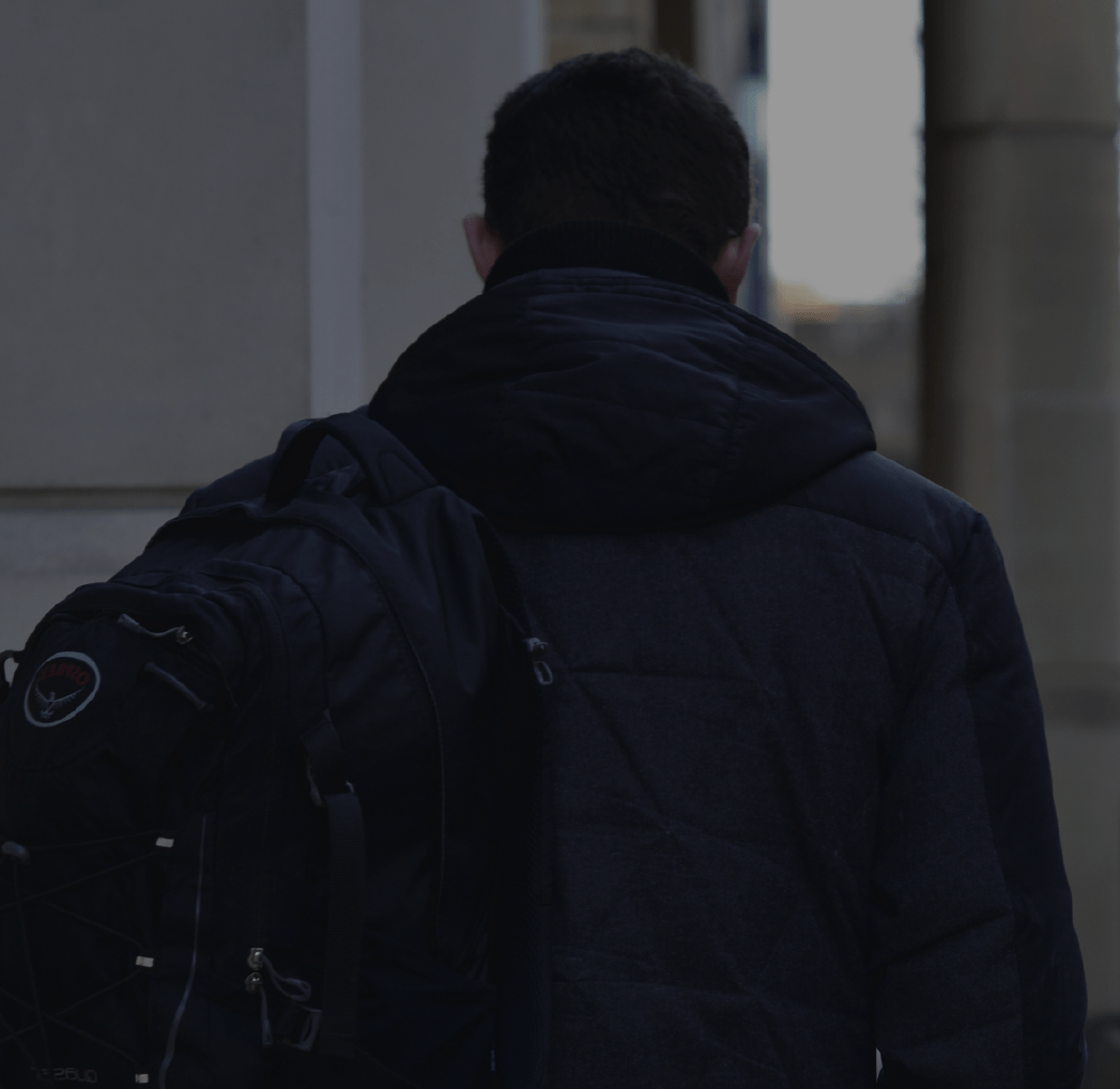Back of a man wearing a backpack