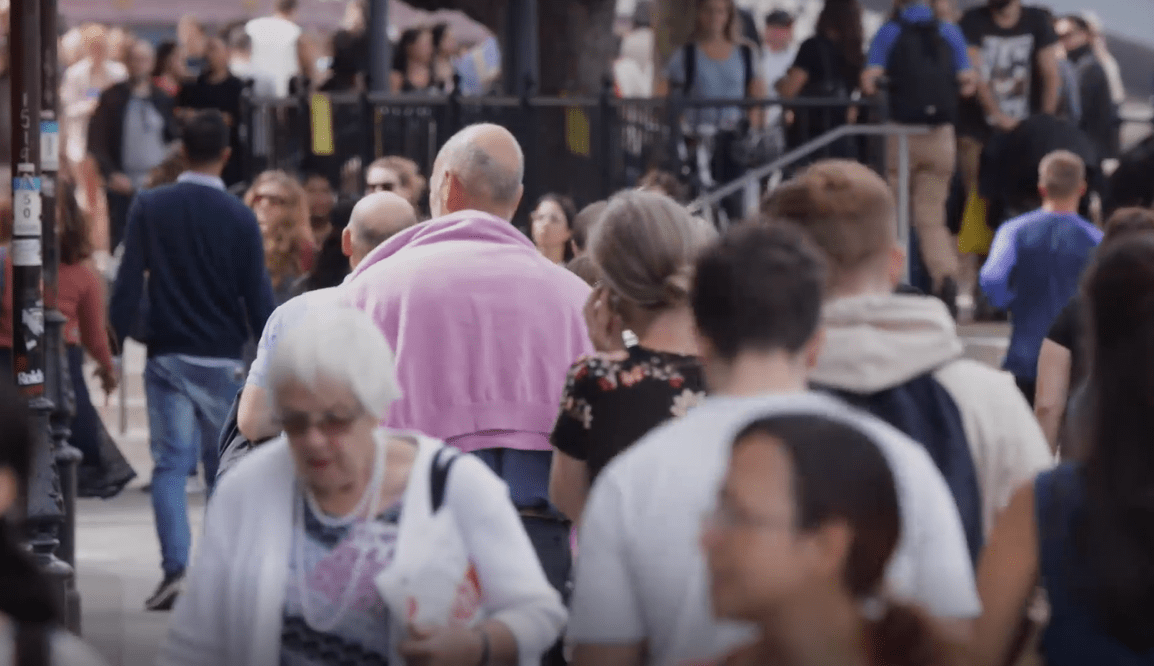 Crowd of people walking around outside