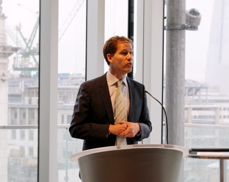 Man giving a speech at a podium