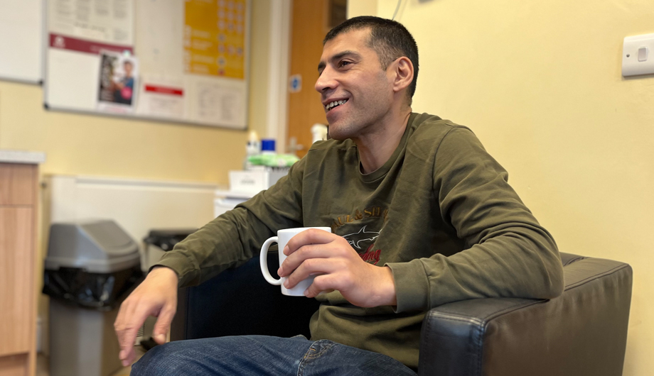 Man holding a mug smiling